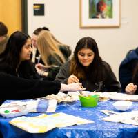 sibs and kids weekend, people sitting at a table and painting